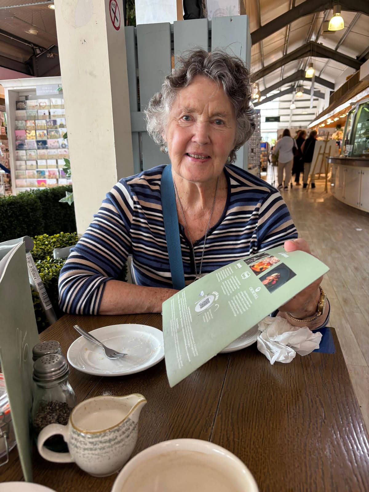 Elderly person enjoying coffee at home — dignified, independent life with nurse-led support